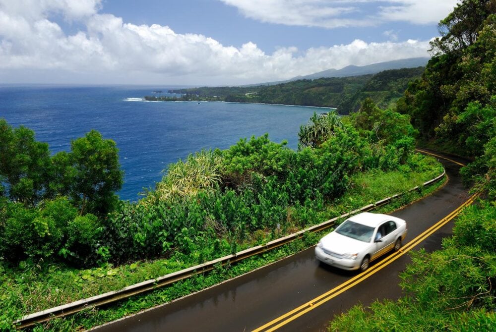 car on hana highway next to beach