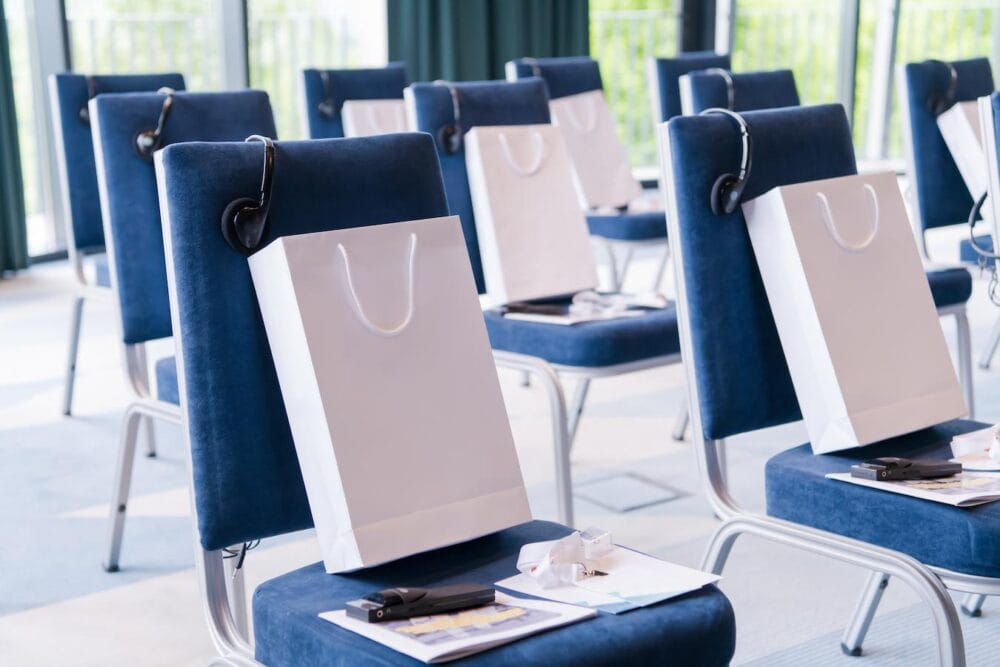 empty chairs at a seminar with gift bags on the chairs online platform swag bag idea swag bags swag bag idea swag